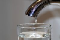 faucet dripping into a cup